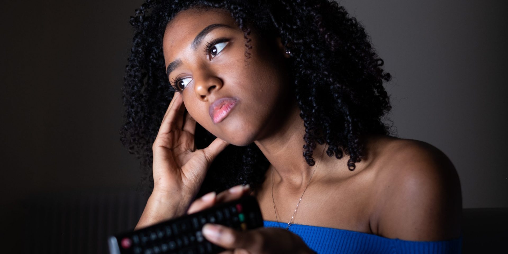 Sad woman with remote control