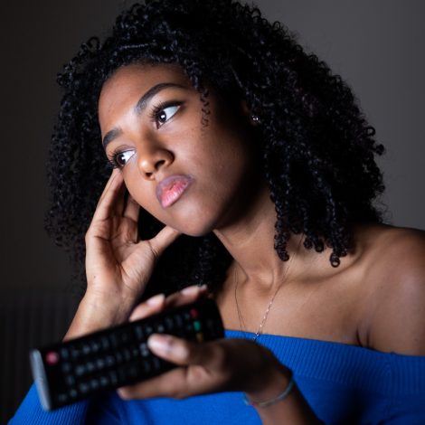 Sad woman with remote control