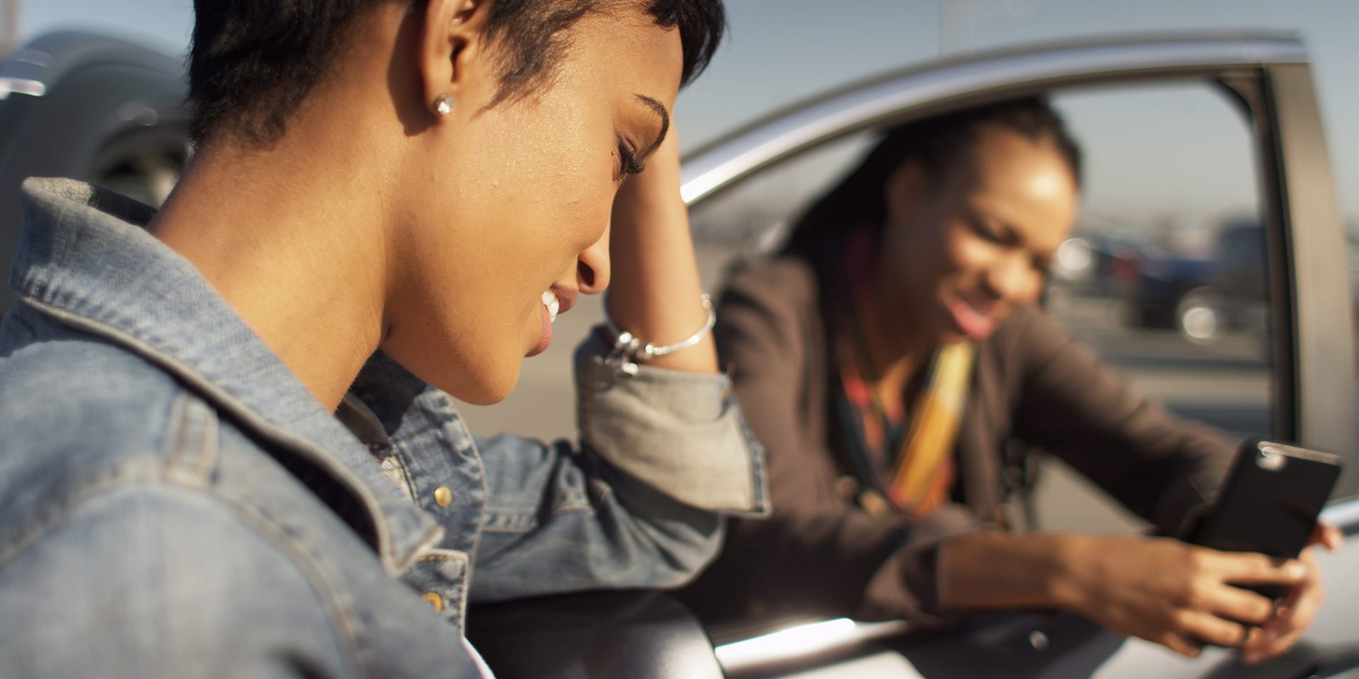 Woman standing next to car