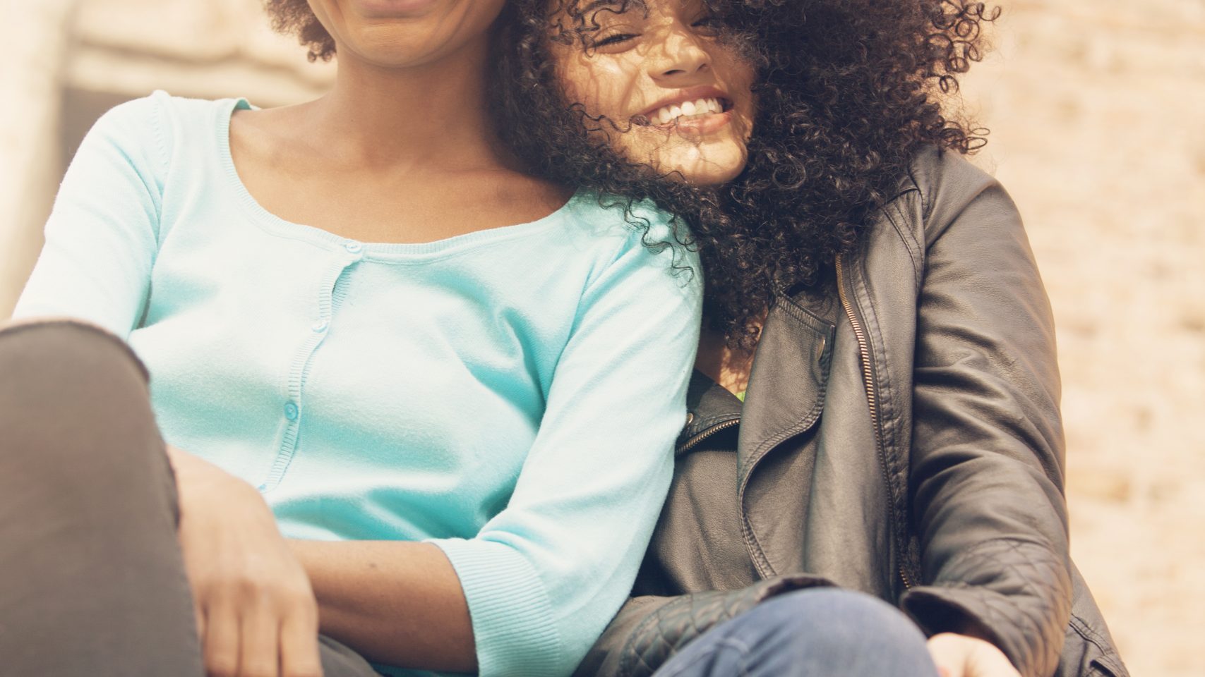 Women smiling while looking down
