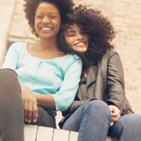 Women smiling while looking down