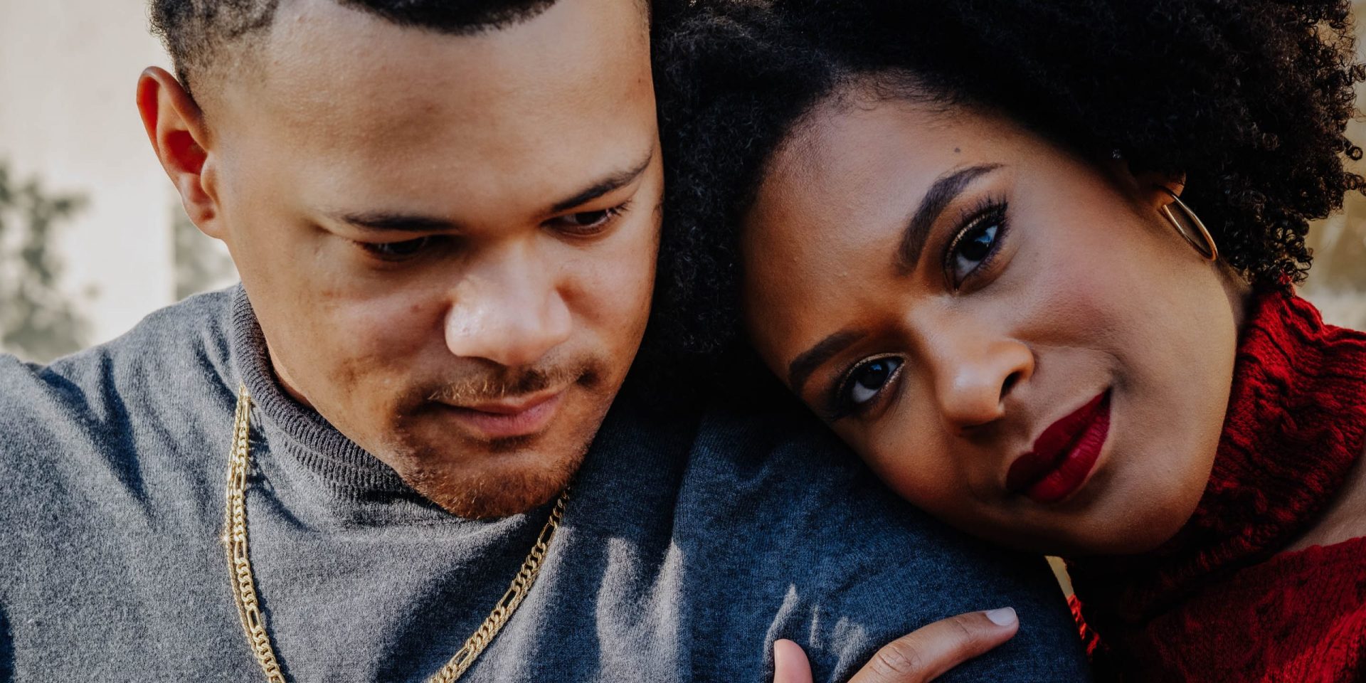 Woman resting head on man's shoulder