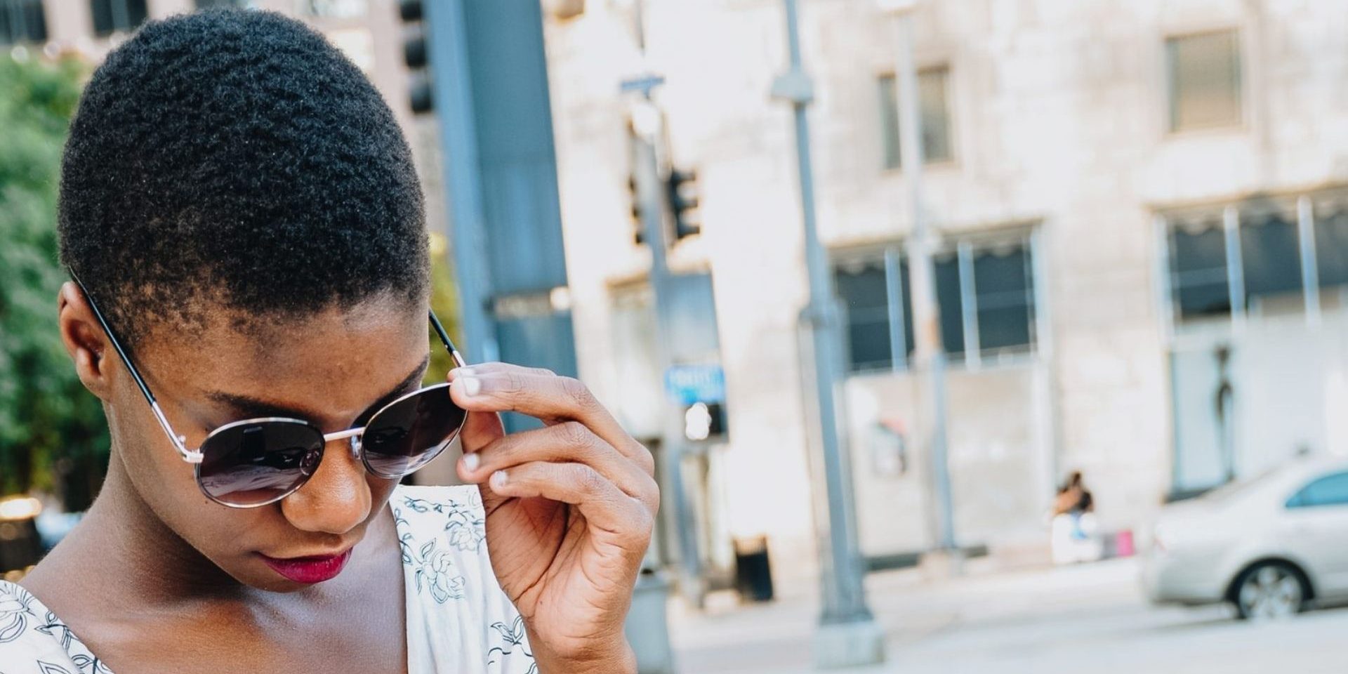 Woman adjusting sunglasses