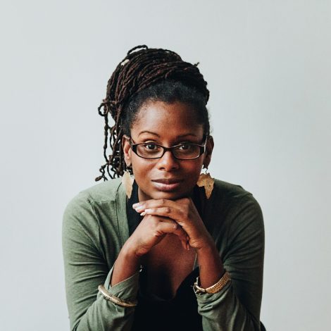 Woman looking forward with head resting on hands