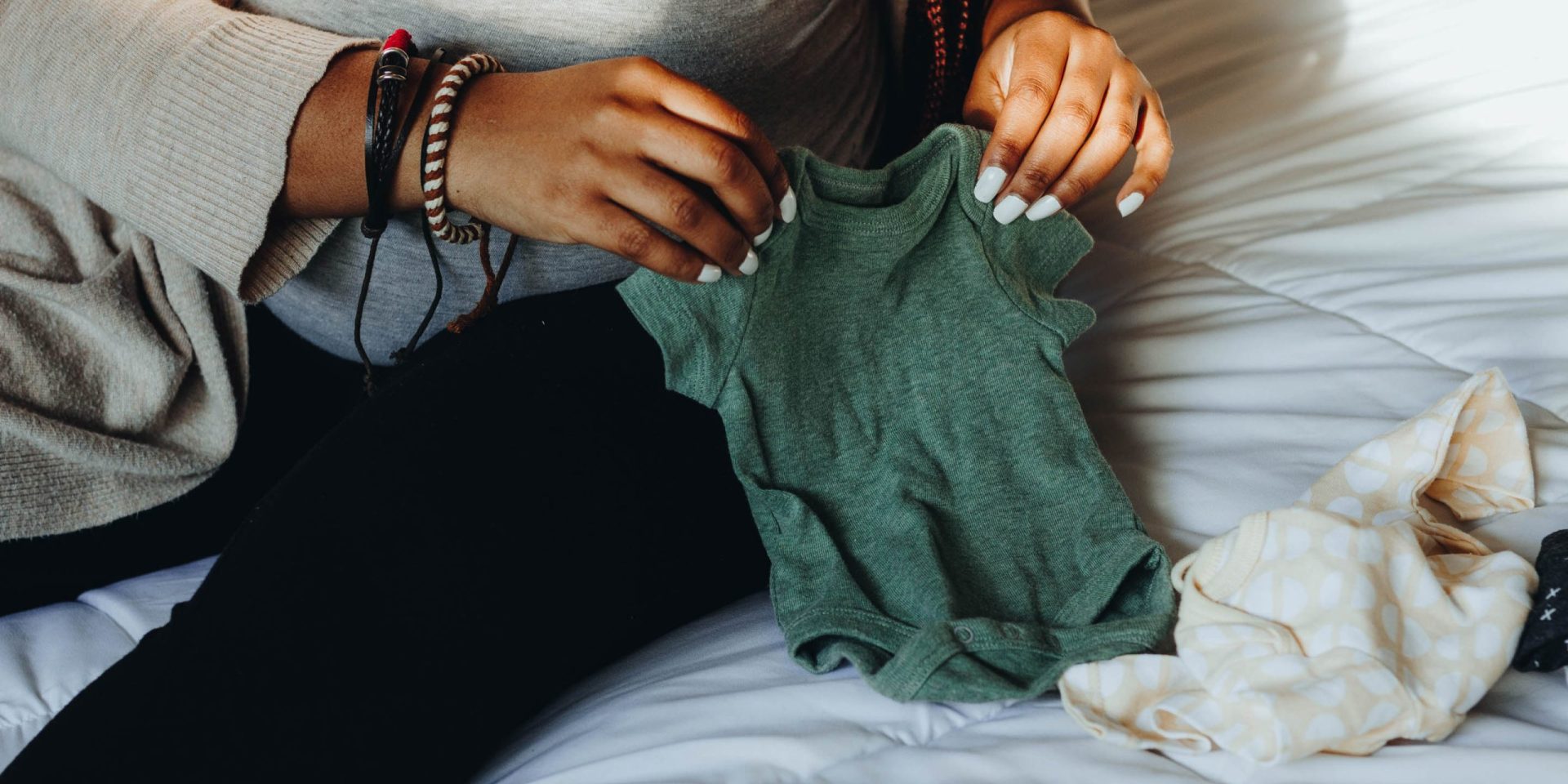 Woman with baby clothes